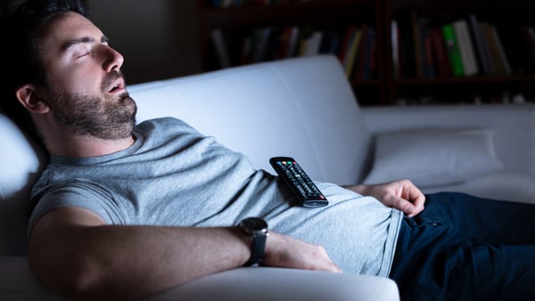 man sleeping watching tv