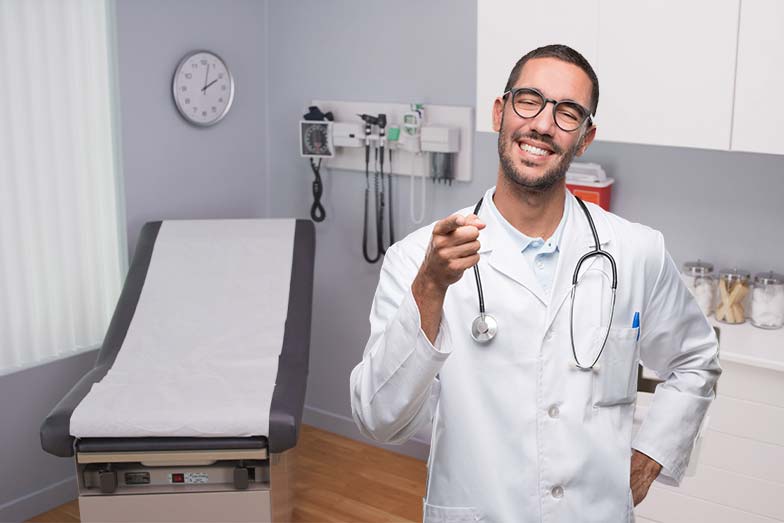 Doctor smiling in the physical examination room