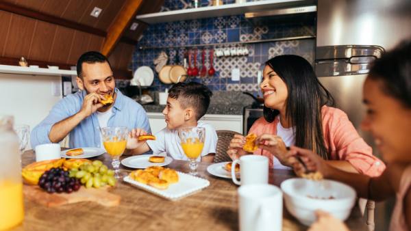 father and mother eating meal with their two children