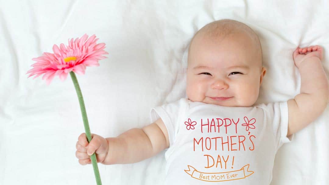 Baby holding mother's day flower