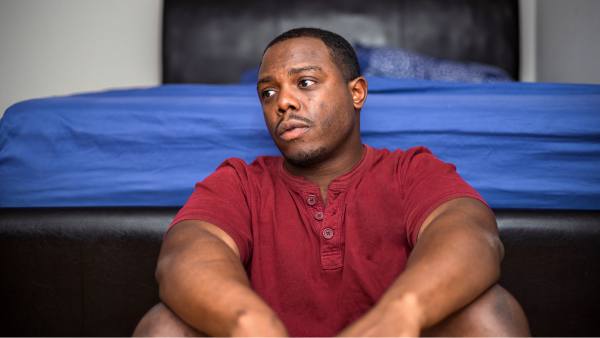 sad man alone in his bedroom