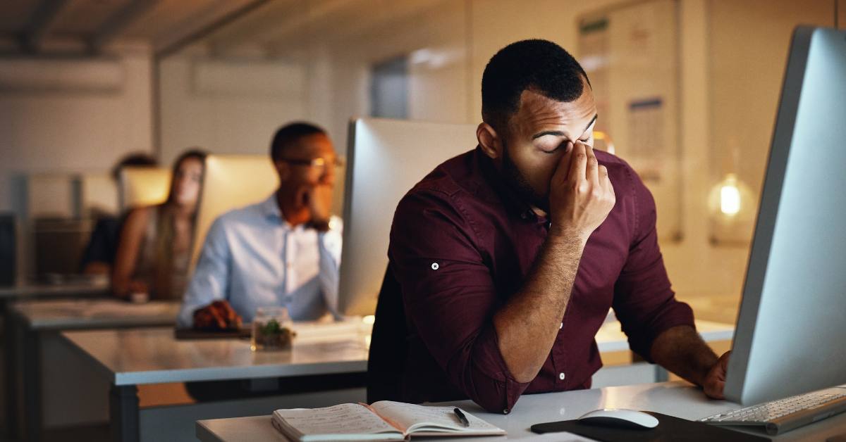 man stressed sitting at desk